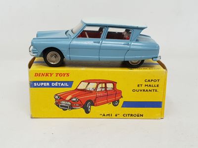 a blue toy car sitting on top of a yellow box