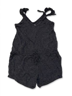 the little girl is wearing a gray romper and a black top