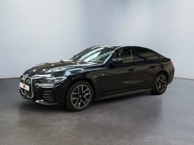 a black bmw x4 parked in a white room