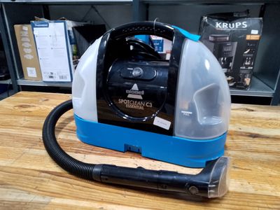 a vacuum that is sitting on a wooden table