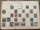 an old book with stamps on it sitting on a table