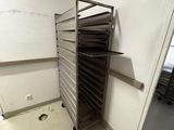 a person standing in a room with a rack of food