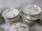 a lot of plates and bowls sitting on a table