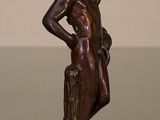an image of a bronze statue of a woman with a goat on her back