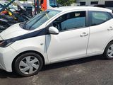 a picture of a small white car parked in a parking lot