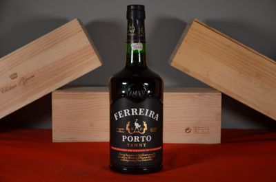 a bottle of wine sitting on a table next to two wooden boxes