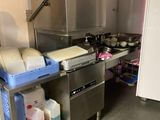 a kitchen with a stove, sink, and refrigerator in it