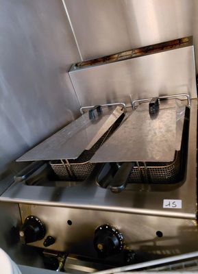 a picture of a commercial fryer with two pans on it