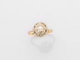 a gold ring with a pearl in the center
