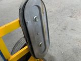 a close up of a yellow hand truck with a tire