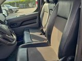 the interior of a car with two rows of seats and a steering wheel