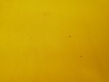 a close up picture of a yellow table cloth