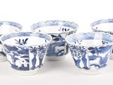 six blue and white cups with animals and trees on them
