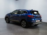 the rear end of a blue car in a showroom