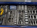 many tools in a blue box on a table
