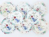 many plates that are arranged together on a white surface