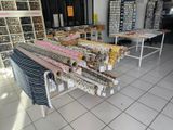many rolls of fabric on a rack in a store