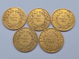 five gold coins with the names of different countries on them