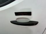 a close up of a car door handle with a sticker on it