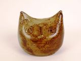 a brown cat shaped vase sitting on a white surface