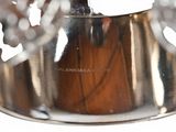 a silver vase with flowers in it on a table