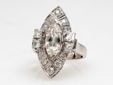 a close up of a diamond ring on a white surface