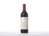 the bottle of red wine is sitting on the table