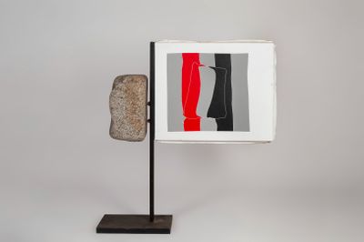 a picture of a sculpture on a stand with a red, black, and white background