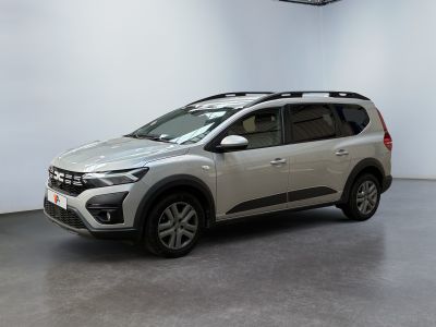 a silver suv parked in a large room with a white wall