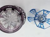 a glass container with a blue ribbon and a clear glass container with a blue ribbon