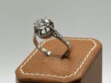 an image of a diamond ring sitting on top of a wooden box
