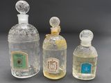 three bottles of perfume sitting next to each other on a table