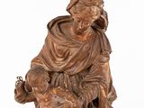 an antique bronze statue of a man holding a child on a rock
