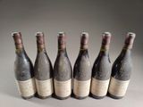 six bottles of wine are lined up in a row