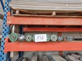 many rolls of metal on a shelf in a warehouse
