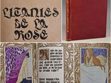 an old book with a picture of a woman in a purple dress and a red book with a picture of a woman in a purple dress