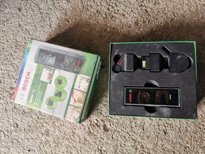 a box with a remote and a game controller in it
