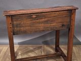 an old wooden table with a drawer underneath it on a parquet floor