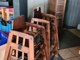 many wooden stools that are sitting in a room