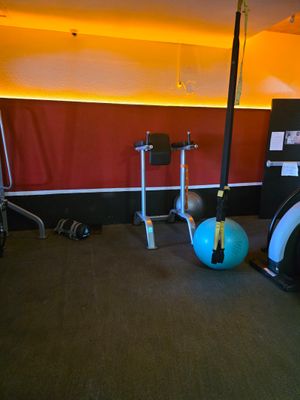a picture of a gym room with exercise equipment