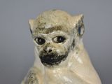 a statue of a monkey sitting on a table
