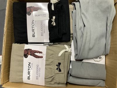 une boîte remplie de vêtements pour hommes posée par terre