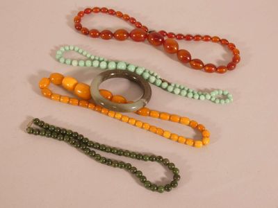 a lot of beads and a ring on a table