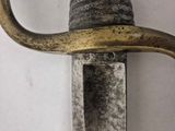 a close up of a knife on a wall