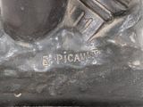 a statue of a man with a pipe on a rock