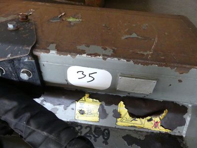 a piece of luggage sitting on the floor next to a person ' s feet