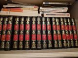 a lot of books that are on a shelf