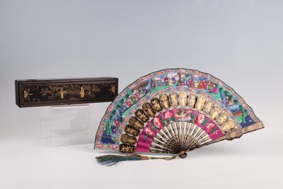 a fan and a box sitting on a white surface
