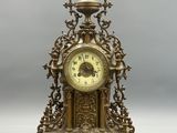 a gold clock sitting on top of a table