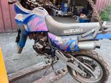 a blue and purple motorcycle parked in front of a building